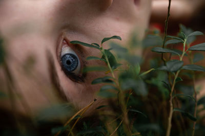 Close-up portrait of woman by plants