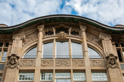 Low angle view of historical building against cloudy sky