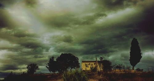 Scenic view of field against cloudy sky
