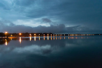 Scenic view of lake against sky at night