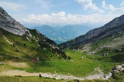 Scenic view of mountains against cloudy sky