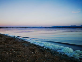 Scenic view of beach against sky during sunset