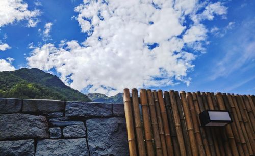 Fence against blue sky and clouds