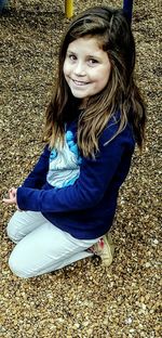 Portrait of smiling young woman sitting outdoors