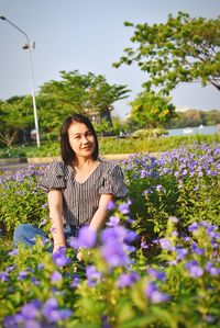 Beautiful woman smiling while standing on field