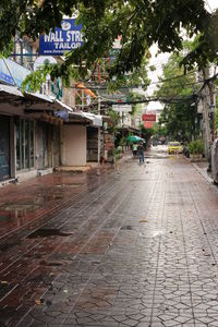 Footpath by street and buildings in city