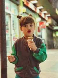 Portrait of girl puckering while holding ice cream