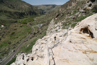 Scenic view of road amidst mountains against sky