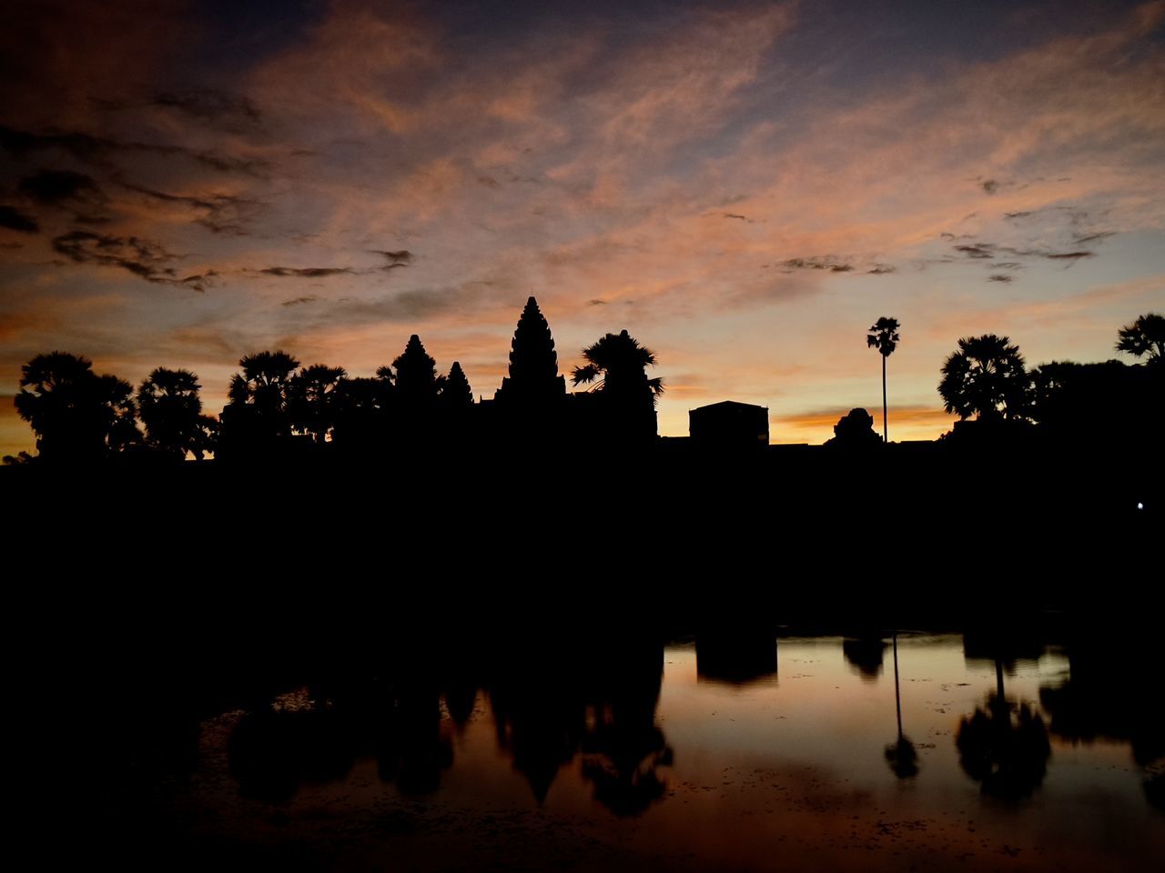 reflection, sky, silhouette, dawn, morning, water, architecture, sunrise, nature, horizon, cloud, built structure, travel destinations, tree, darkness, afterglow, building, no people, religion, building exterior, lake, temple - building, beauty in nature, tranquility, history, outdoors, sunlight, travel, scenics - nature, the past, plant, skyline, city, belief