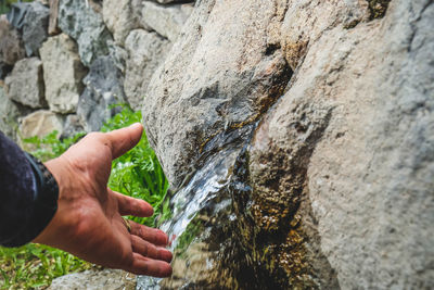 Person hand on rock