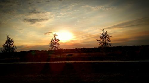 Silhouette trees against sky during sunset