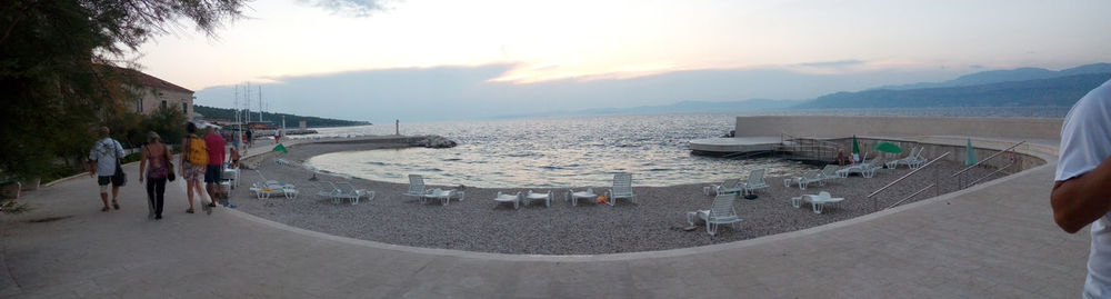 People on beach against sky