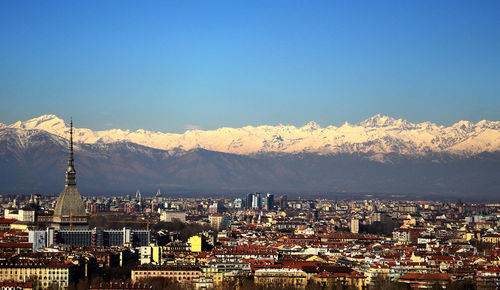 View of cityscape against mountain range