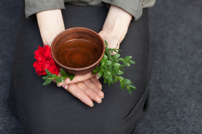 Midsection of woman holding herbal tea