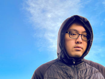 Portrait of a young man against blue sky