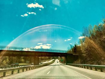 Road against blue sky in city