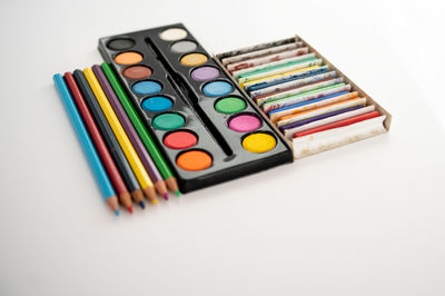 High angle view of multi colored pencils on white table
