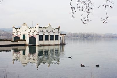 Scenic view of lake by building against sky