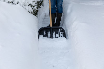 Low section of person on snow covered field