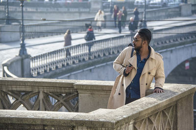 Young man looking away at bridge