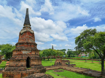 Old temple building against cloudy sky