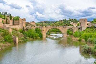 Scenic view of medieval san martin's bridge offering views of the tagus river in toledo, spain