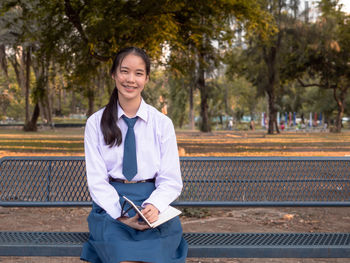 Portrait of a smiling girl standing outdoors