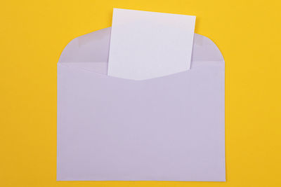 Close-up of paper against yellow background