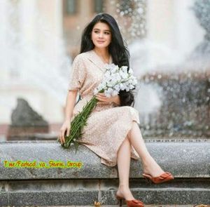 Portrait of a smiling young woman holding flower