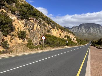 Rear view of man walking on road