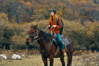 Young woman riding horse