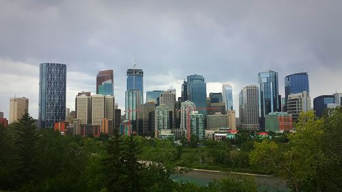 Modern buildings against cloudy sky