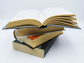 Close-up of heart shape on book against white background