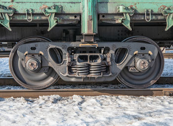 Close-up of train at railroad tracks during winter