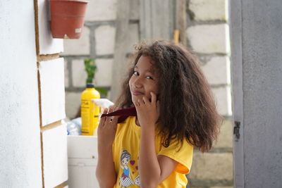 Portrait of woman holding camera