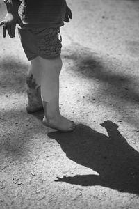 Low section of people walking on street