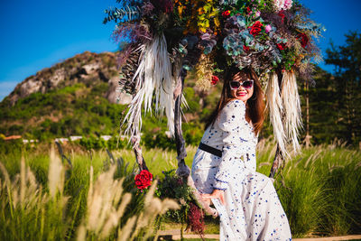 Portrait of woman standing by plants