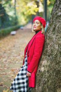 Portrait of young woman standing in forest