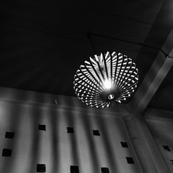Low angle view of illuminated pendant lights hanging from ceiling