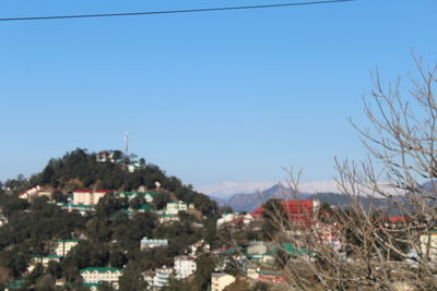 Townscape against clear blue sky