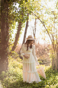 Portrait of woman standing in forest