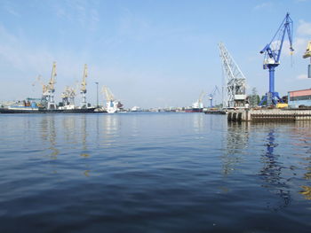 Commercial dock by sea against sky