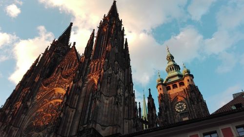 Low angle view of church against cloudy sky