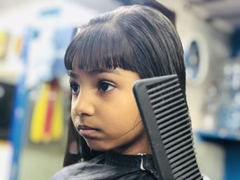 Close-up portrait of teenage girl looking away