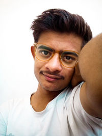 Portrait of young man against white background