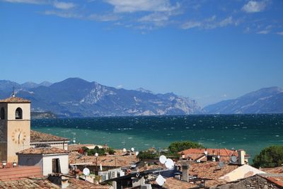 Townscape by sea against sky
