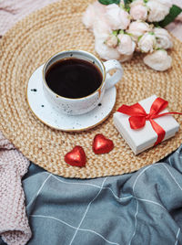 Romantic breakfast with coffee, gift box and rose flowers.