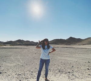 Full length of man standing on mountain against clear sky