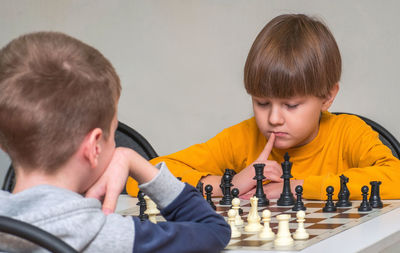 Two boys are playing chess at a chess tournament.