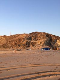 Scenic view of desert against clear blue sky